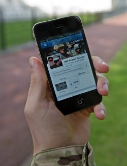 1657px A serviceman accesses social media channels using a smart phone outside MOD Main Building in London MOD 45156046