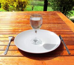 1238px Fasting 4 Fasting a glass of water on an empty plate