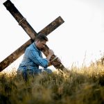 imagem superficial de um homem carregando uma cruz feita a mao